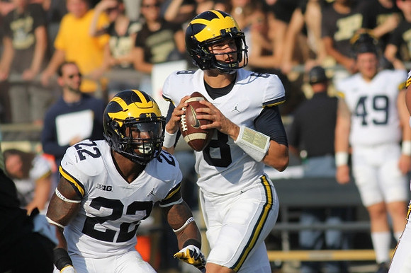 Karan Higdon (22) and John O'Korn (8)