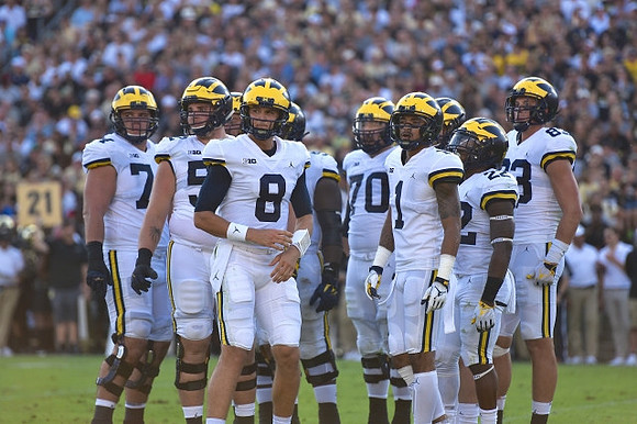 Ben Bredeson (74), Mason Cole (52), John O'Korn (8), Nolan Ulizio (70), Kekoa Crawford (1), Karan Higdon (22), and Zach Gentry (83)