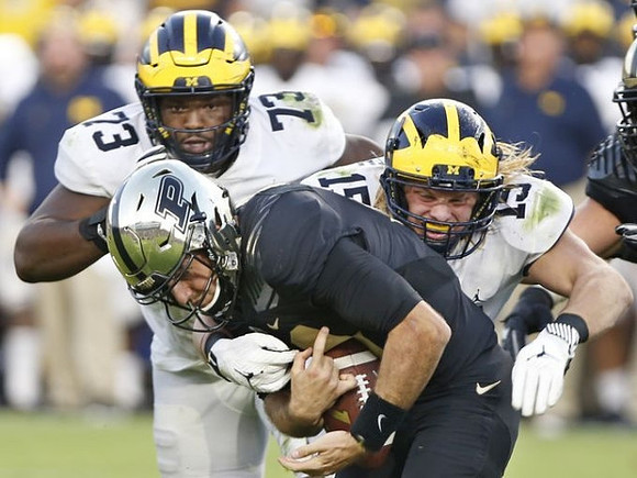 Maurice Hurst (73) and Chase Winovich (15)