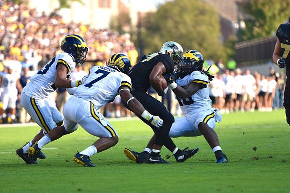 Tyree Kinnel (23), Khaleke Hudson (7), and Devin Bush (10)