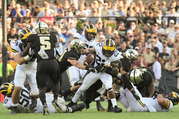 Michael Onwenu (50), Sean McKeon (84), Mason Cole (52), and Karan Higdon (22)