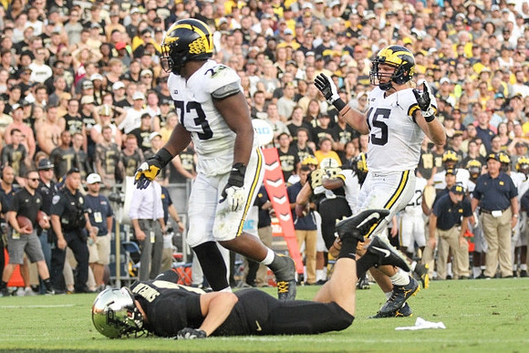 Maurice Hurst (73) and Chase Winovich (15)