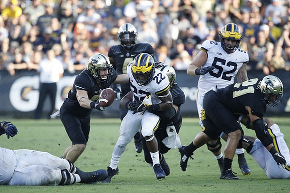 Karan Higdon (22) and Mason Cole (52)