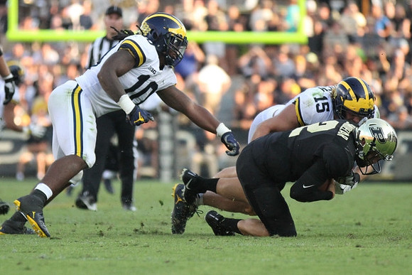 Devin Bush (10) and Chase Winovich (15)