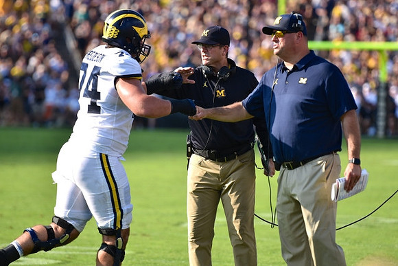 Ben Bredeson (74), Jim Harbaugh, and Greg Frey
