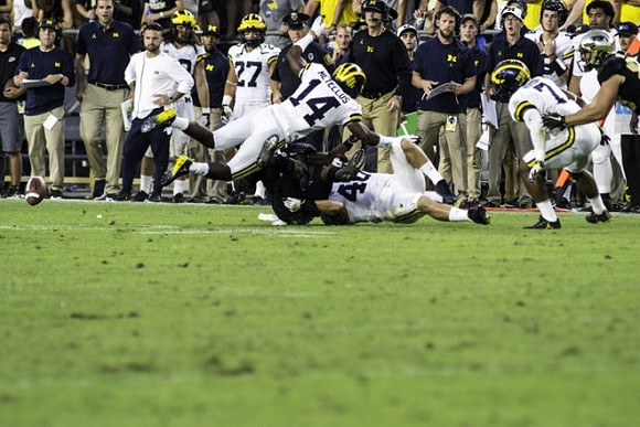 Josh Metellus (14), Michael Wroblewski (46), and Khaleke Hudson (7)