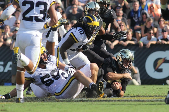 Tyree Kinnel (23), Alex Kaminski (58), and Devin Bush (10)