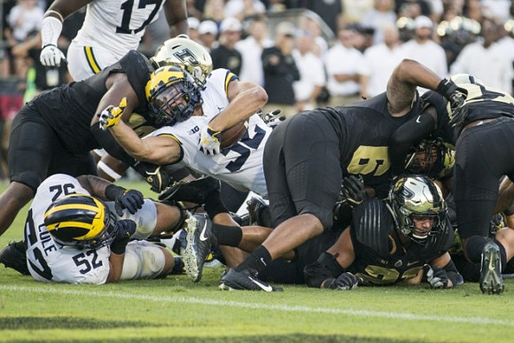 Mason Cole (52), Ty Isaac (32), and Tyrone Wheatley Jr. (17)