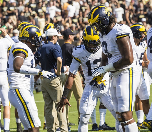 Josh Metellus (14), Josh Ross (12), and Rashan Gary (3)