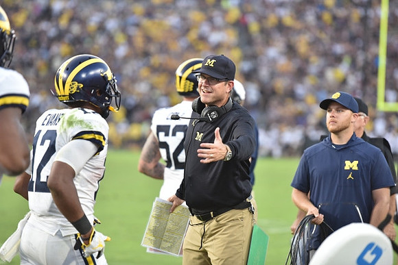 Chris Evans (12), Jim Harbaugh, and Mason Cole (52)