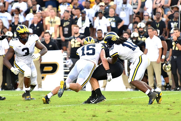 Rashan Gary (3), Chase Winovich (15), and Devin Bush (10)
