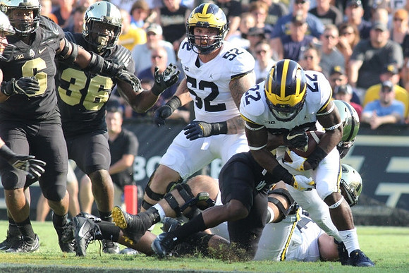 Mason Cole (52) and Karan Higdon (22)