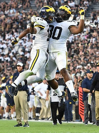 Chris Evans (12), Khalid Hill (80), and Jay Harbaugh