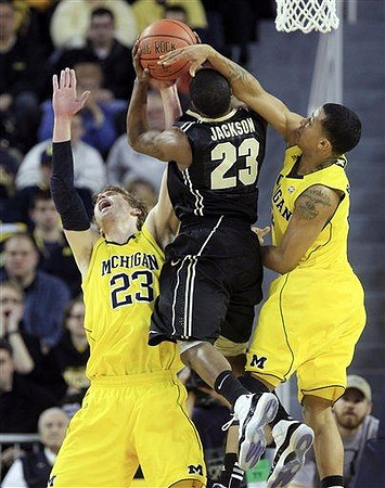 Evan Smotrycz (23) and Trey Burke (3)