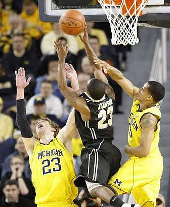 Evan Smotrycz (23) and Trey Burke (3)