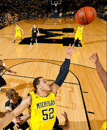 Jordan Morgan (52), Zack Novak (0), and Trey Burke (3)