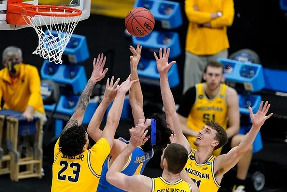 Brandon Johns Jr. (23), Hunter Dickinson (1), and Franz Wagner (21)