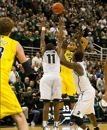 Evan Smotrycz (23) and Trey Burke (3)