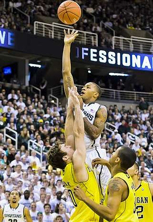 Zack Novak (0), Trey Burke (3), and Jordan Morgan (52)