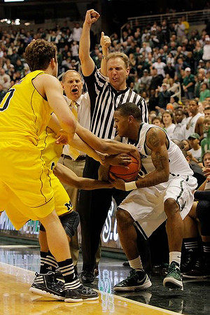 Trey Burke (3), Zack Novak (0), and John Beilein