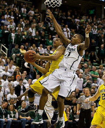 Trey Burke (3) and Blake McLimans (22)