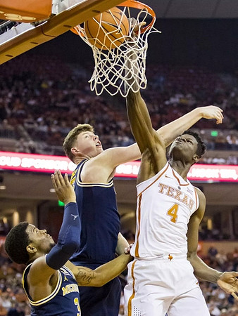 Jon Teske (15) and Zavier Simpson (3)