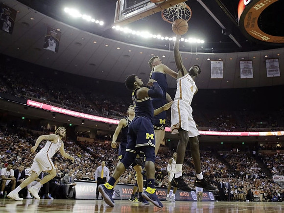 Duncan Robinson (22), Zavier Simpson (3), and Jon Teske (15)