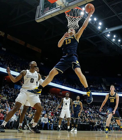 Ignas Brazdeikis (13), Zavier Simpson (3), and Jon Teske (15)
