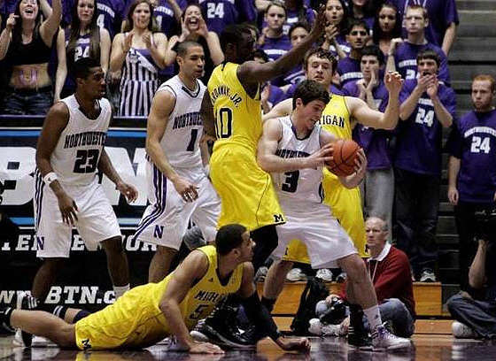 Jordan Morgan (52), Tim Hardaway Jr. (10), and Zack Novak (0)