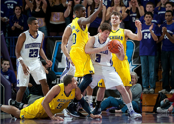 Jordan Morgan (52), Tim Hardaway Jr. (10), and Zack Novak (0)
