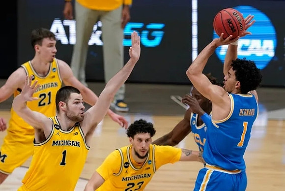 Franz Wagner (21), Hunter Dickinson (1), and Brandon Johns Jr. (23)