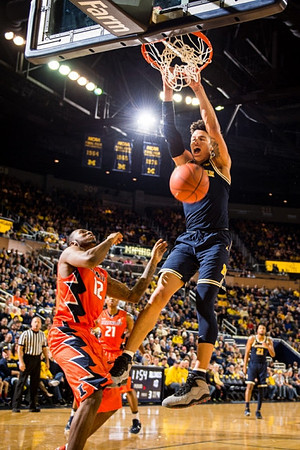 D.J. Wilson (5) and Zak Irvin (21)