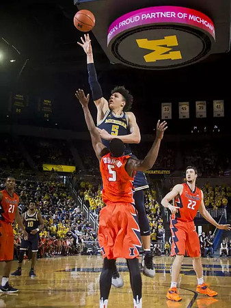 D.J. Wilson (5) and Derrick Walton Jr. (10)