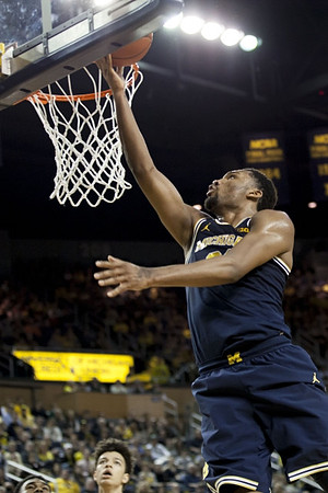 D.J. Wilson (5) and Zak Irvin (21)
