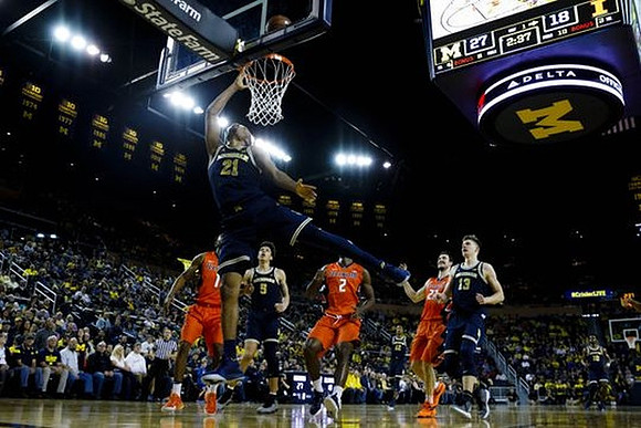 D.J. Wilson (5), Zak Irvin (21), and Moritz Wagner (13)