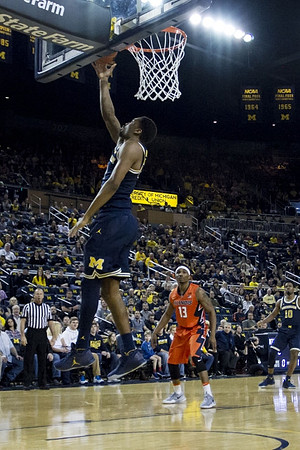 Zak Irvin (21) and Derrick Walton Jr. (10)