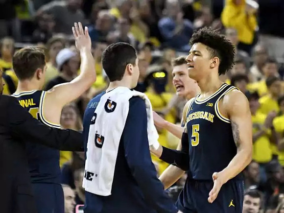 D.J. Wilson (5) and Michigan Team