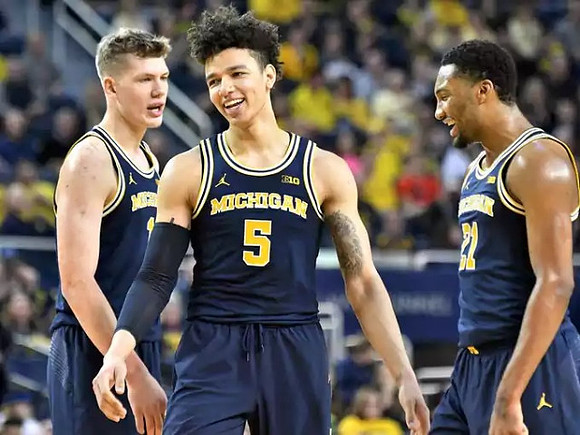 Moritz Wagner (13), D.J. Wilson (5), and Zak Irvin (21)