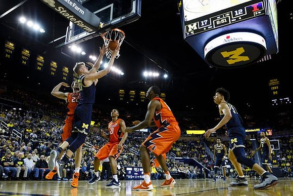 Moritz Wagner (13), D.J. Wilson (5), and Derrick Walton Jr. (10)