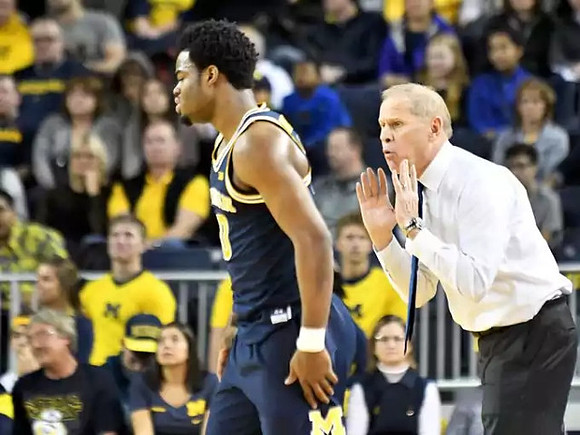 Derrick Walton Jr. (10) and John Beilein