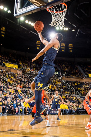 Zak Irvin (21) and Derrick Walton Jr. (10)