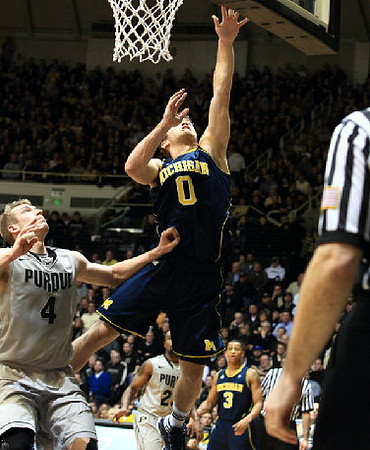Zack Novak (0) and Trey Burke (3)