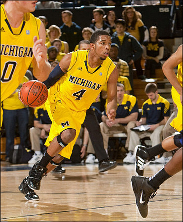 Zack Novak (0) and Darius Morris (4)