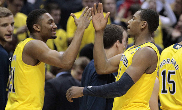 Zak Irvin (21), Glenn Robinson III (1), and Jon Horford (15)