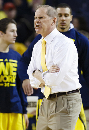 Andrew Dakich (5), Jordan Morgan (52), and John Beilein