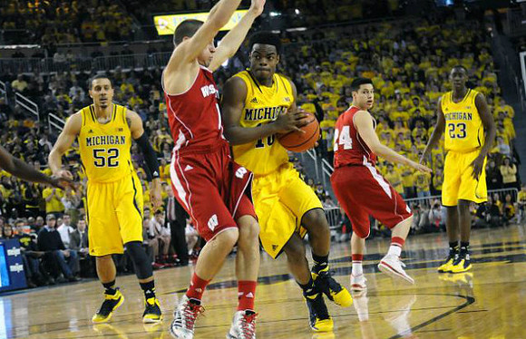 Jordan Morgan (52), Derrick Walton Jr. (10), and Caris LeVert (23)