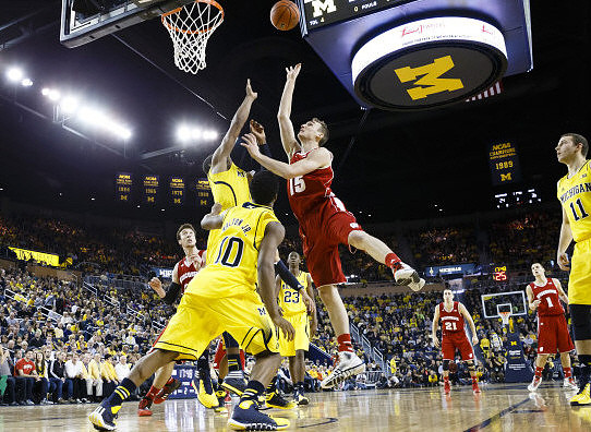 Derrick Walton Jr. (10), Caris LeVert (23), and Nik Stauskas (11)