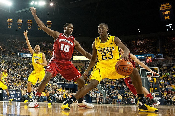 Zak Irvin (21), Jon Horford (15), and Caris LeVert (23)