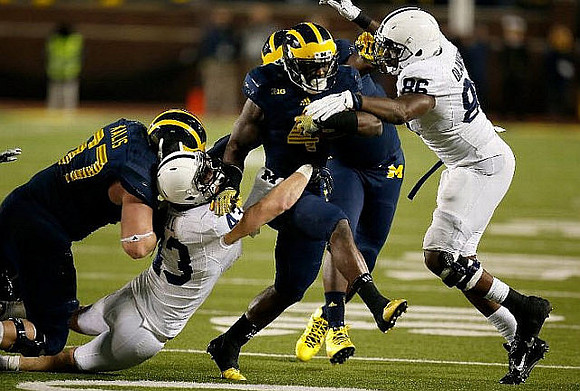 Kyle Kalis (67) and De'Veon Smith (4)