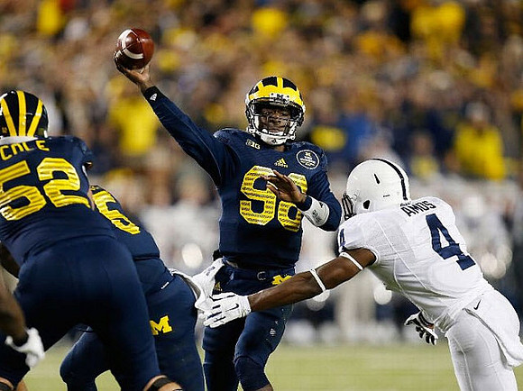 Mason Cole (52) and Devin Gardner (98)